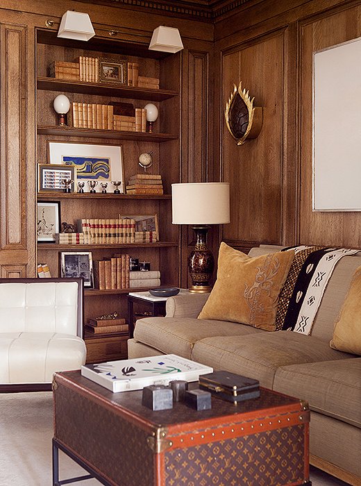 The neutral palette and the well-organized bookshelves make this library an oasis. Photo by Erica George-Dines; design by Suzanne Kasler.
